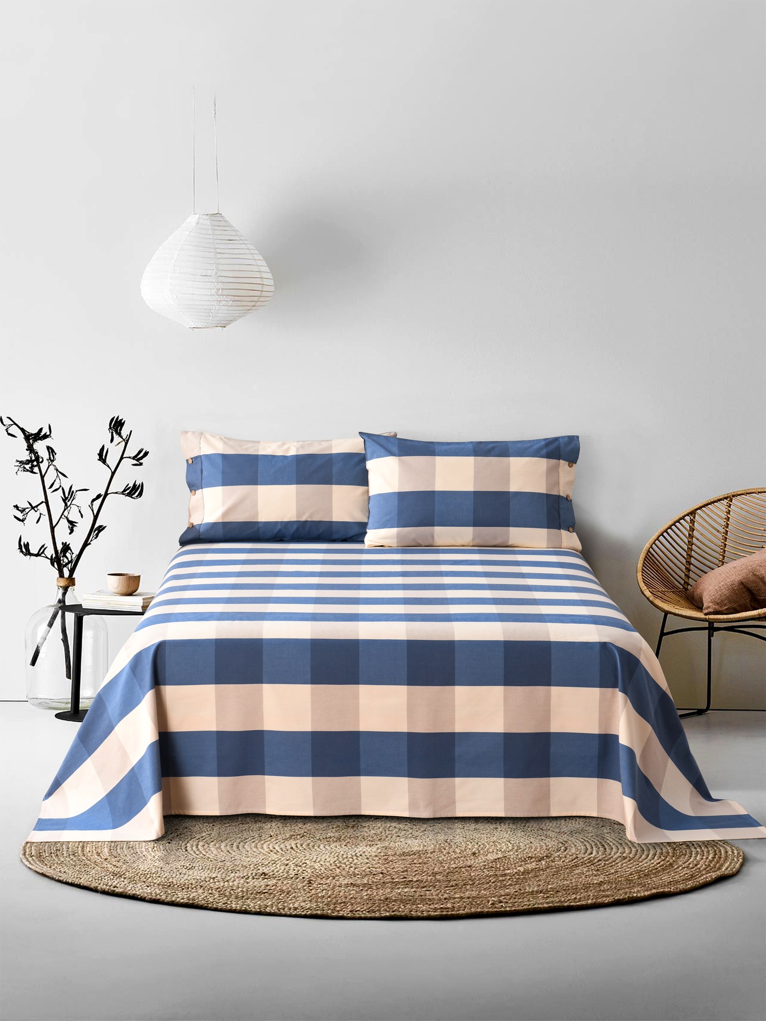 Green-blue woven cotton design shown as finished bedding